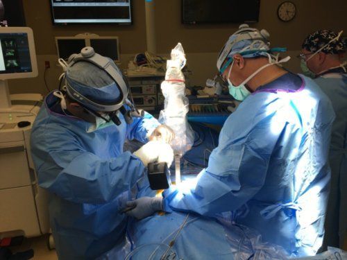 picture of Doctor Payam Moazzaz performing robotic spine surgery